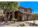 Beautifully landscaped front yard of a brown two story home with desert landscaping at 1405 E Aloe Dr, Chandler, AZ 85286