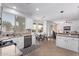 Modern kitchen features white cabinets, granite countertops, and a view into the dining and living areas at 1405 E Aloe Dr, Chandler, AZ 85286