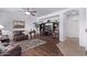Cozy living room featuring wood floors, a ceiling fan, a TV, built-in shelves, and comfortable seating at 1405 E Aloe Dr, Chandler, AZ 85286