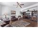 Cozy living room with hardwood floors, ceiling fan, built-in shelves and a comfortable seating area at 1405 E Aloe Dr, Chandler, AZ 85286