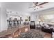 Open-concept living area with hardwood floors, lots of natural light, ceiling fan, and a breakfast bar at 1405 E Aloe Dr, Chandler, AZ 85286