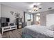 Main bedroom with hardwood floors, ceiling fan, and en suite bath with large window at 1405 E Aloe Dr, Chandler, AZ 85286