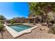 Inviting backyard pool with desert landscaping and covered patio, perfect for outdoor relaxation and entertaining at 1405 E Aloe Dr, Chandler, AZ 85286