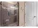 A tile shower with glass door, built-in seat, and storage shelf at 1405 E Aloe Dr, Chandler, AZ 85286