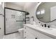Bathroom featuring a glass shower, large vanity, and modern fixtures at 1411 E Orangewood Ave # 233, Phoenix, AZ 85020