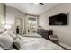 Bright bedroom with a ceiling fan, muted tones, and a door to the balcony at 1411 E Orangewood Ave # 233, Phoenix, AZ 85020