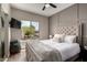 Bedroom featuring an tufted headboard and large windows at 1411 E Orangewood Ave # 233, Phoenix, AZ 85020