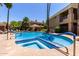 Community pool with inset spa, lounge chairs and umbrellas to enjoy on sunny days at 1411 E Orangewood Ave # 233, Phoenix, AZ 85020