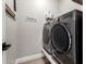 Modern laundry room featuring stainless steel appliances and a 