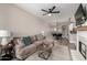 Spacious living room with comfortable sofa and open to dining area and modern kitchen at 1411 E Orangewood Ave # 233, Phoenix, AZ 85020