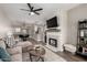 Open floor plan featuring stylish living room with fireplace and view to dining area and kitchen at 1411 E Orangewood Ave # 233, Phoenix, AZ 85020