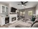 Comfortable living room with fireplace, adjacent to the dining area and access to balcony at 1411 E Orangewood Ave # 233, Phoenix, AZ 85020