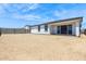Backyard features cinder block perimeter, desert-style landscaping, and covered patio at 15389 W Cottontail Ln, Surprise, AZ 85387