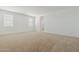 Spacious bedroom featuring neutral carpet, natural light, and fresh neutral paint at 15389 W Cottontail Ln, Surprise, AZ 85387