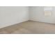 Well-lit bedroom featuring neutral carpet, window, and fresh neutral paint at 15389 W Cottontail Ln, Surprise, AZ 85387