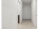 Bright hallway with neutral paint, tile floors, and doors leading to various rooms at 15389 W Cottontail Ln, Surprise, AZ 85387