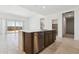 Close up shot of the kitchen island with stainless steel dishwasher, sink, and bar seating at 15389 W Cottontail Ln, Surprise, AZ 85387