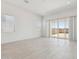 Bright living room featuring neutral paint, tile flooring, and sliding door access to the backyard at 15389 W Cottontail Ln, Surprise, AZ 85387