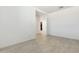 Open living room featuring neutral paint, tile flooring, and a seamless hallway at 15389 W Cottontail Ln, Surprise, AZ 85387