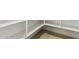 Bright walk-in pantry with lots of white shelving and wood-look tile flooring at 15389 W Cottontail Ln, Surprise, AZ 85387