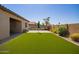 Large backyard featuring a green lawn and a patio area, an ideal setting for outdoor gatherings and entertainment at 15862 W Fillmore St, Goodyear, AZ 85338