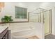 This bathroom features a soaking tub and a separate shower with glass doors at 15862 W Fillmore St, Goodyear, AZ 85338