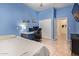 Cozy blue bedroom with a desk, ample storage, and a serene atmosphere, perfect for relaxation or study at 15862 W Fillmore St, Goodyear, AZ 85338