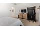 Comfortable bedroom featuring a dresser with a TV, a treadmill, and neutral decor at 15862 W Fillmore St, Goodyear, AZ 85338