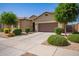 Lovely single-story home with a well-manicured front yard and a two-car garage, providing a charming and inviting curb appeal at 15862 W Fillmore St, Goodyear, AZ 85338