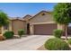 Attractive single-story home featuring a manicured front yard and a two-car garage, offering a warm and inviting curb appeal at 15862 W Fillmore St, Goodyear, AZ 85338