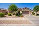 Charming single-story home boasts a well-manicured front yard and inviting curb appeal at 15862 W Fillmore St, Goodyear, AZ 85338