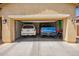 Spacious two car garage featuring a white SUV and a blue truck, offering ample parking and storage space at 15862 W Fillmore St, Goodyear, AZ 85338