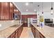 Spacious kitchen featuring granite counters, tile backsplash and stainless steel appliances at 15862 W Fillmore St, Goodyear, AZ 85338