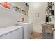 Functional laundry room with ample storage shelves and modern appliances, making laundry chores a breeze at 15862 W Fillmore St, Goodyear, AZ 85338