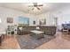 Comfortable living room with neutral colors, a ceiling fan and a sliding glass door at 15862 W Fillmore St, Goodyear, AZ 85338