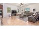 Spacious living room with tile floors, large windows, and ceiling fan at 15862 W Fillmore St, Goodyear, AZ 85338