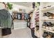 Spacious walk-in closet with ample storage including shelves, drawers, and hanging space at 15862 W Fillmore St, Goodyear, AZ 85338