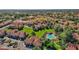 Aerial view of the community with lush green lawns, mature trees, and a sparkling community pool at 1633 E Lakeside Dr # 127, Gilbert, AZ 85234