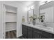 Bathroom featuring double sinks, a granite countertop, and a view into the walk-in closet area for ample storage at 1633 E Lakeside Dr # 127, Gilbert, AZ 85234
