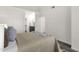 Cozy bedroom with neutral tones and a glimpse into the adjacent bathroom area; features sleek, wood-look flooring at 1633 E Lakeside Dr # 127, Gilbert, AZ 85234