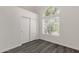 Bright bedroom featuring modern window and closet with sliding doors, offering ample natural light and sleek gray floors at 1633 E Lakeside Dr # 127, Gilbert, AZ 85234