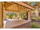 Relaxing shaded community area with table and chairs, surrounded by manicured landscaping at 1633 E Lakeside Dr # 127, Gilbert, AZ 85234