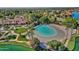 Gorgeous aerial view featuring a community lagoon beach with beach entry, palm trees, landscaping and a community clubhouse at 1633 E Lakeside Dr # 127, Gilbert, AZ 85234