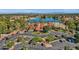 Aerial view of the community center and lake with lush landscaping, mature palms, and ample parking at 1633 E Lakeside Dr # 127, Gilbert, AZ 85234