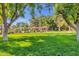 Expansive community green space featuring mature trees and view of the pool and cabanas at 1633 E Lakeside Dr # 127, Gilbert, AZ 85234