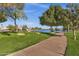 Scenic lakeside community park with walking path, grassy lawn, mature trees, and serene water views at 1633 E Lakeside Dr # 127, Gilbert, AZ 85234