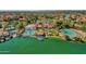 Aerial view of the waterfront community clubhouse and pool with lake, beach and surrounding areas at 1633 E Lakeside Dr # 127, Gilbert, AZ 85234