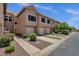 Exterior view of a townhouse with tidy landscaping, driveways, and lawns at 1633 E Lakeside Dr # 127, Gilbert, AZ 85234