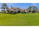 A tan two story home with a tile roof and large green lawn at 1633 E Lakeside Dr # 127, Gilbert, AZ 85234