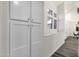 Hallway area features built-in storage cabinets, complemented by natural light from the transom window at 1633 E Lakeside Dr # 127, Gilbert, AZ 85234